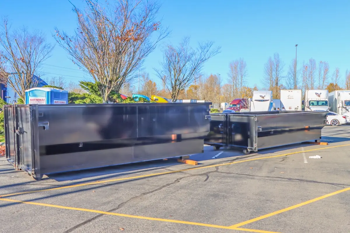 Professional dumpster rental service with roll-off container on residential driveway in Delafield
